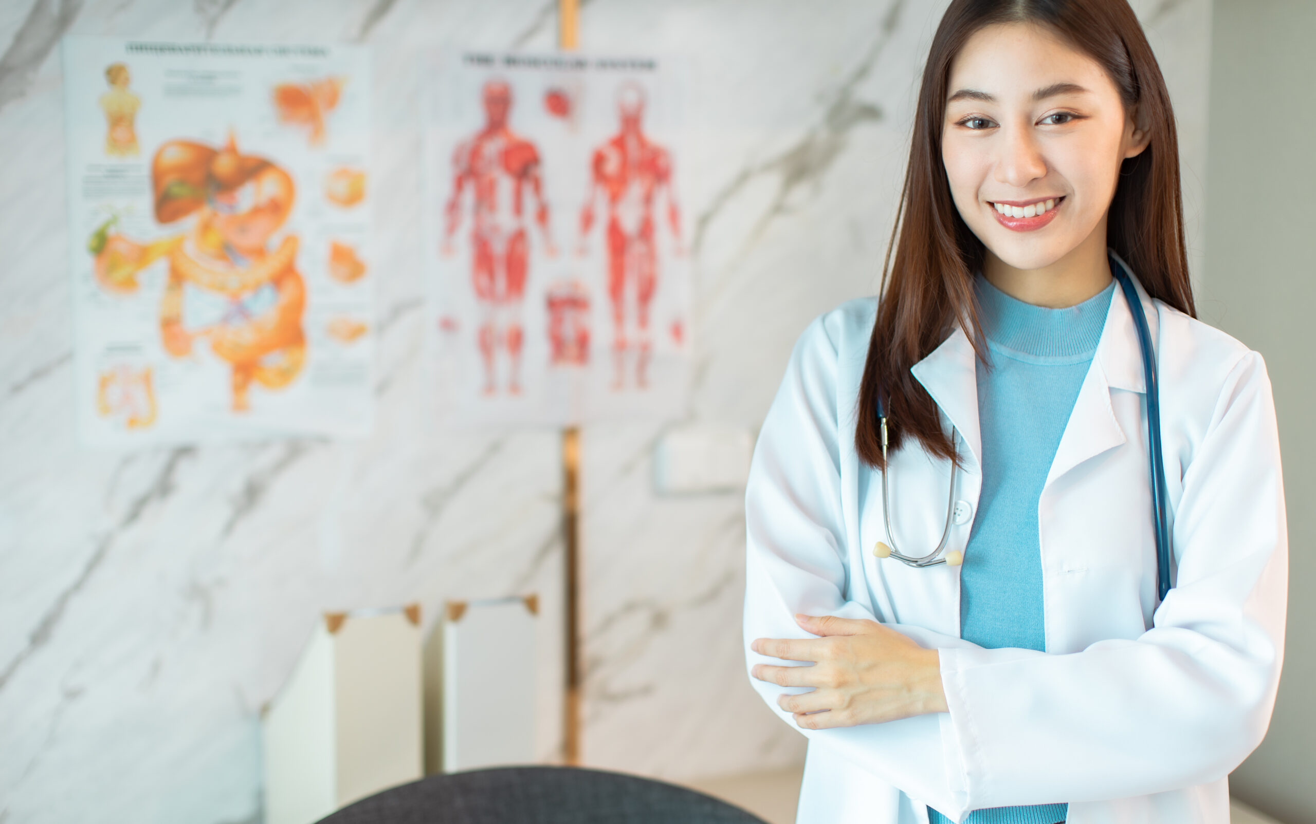 Smiling female doctor in white coat with stethoscope, promoting women's health and Pap smear screenings.