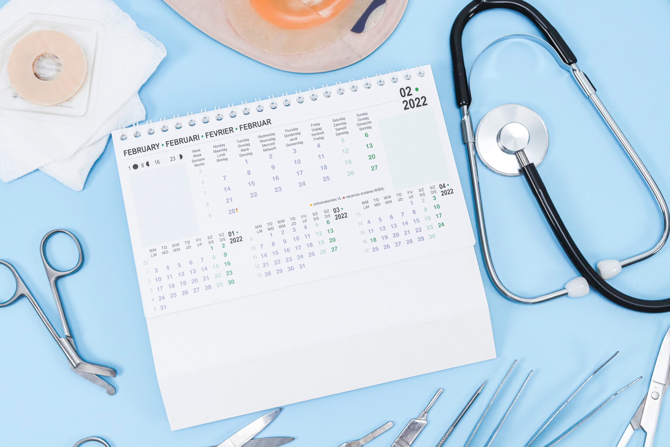 February 2022 calendar with medical tools and supplies. STD testing and treatment.