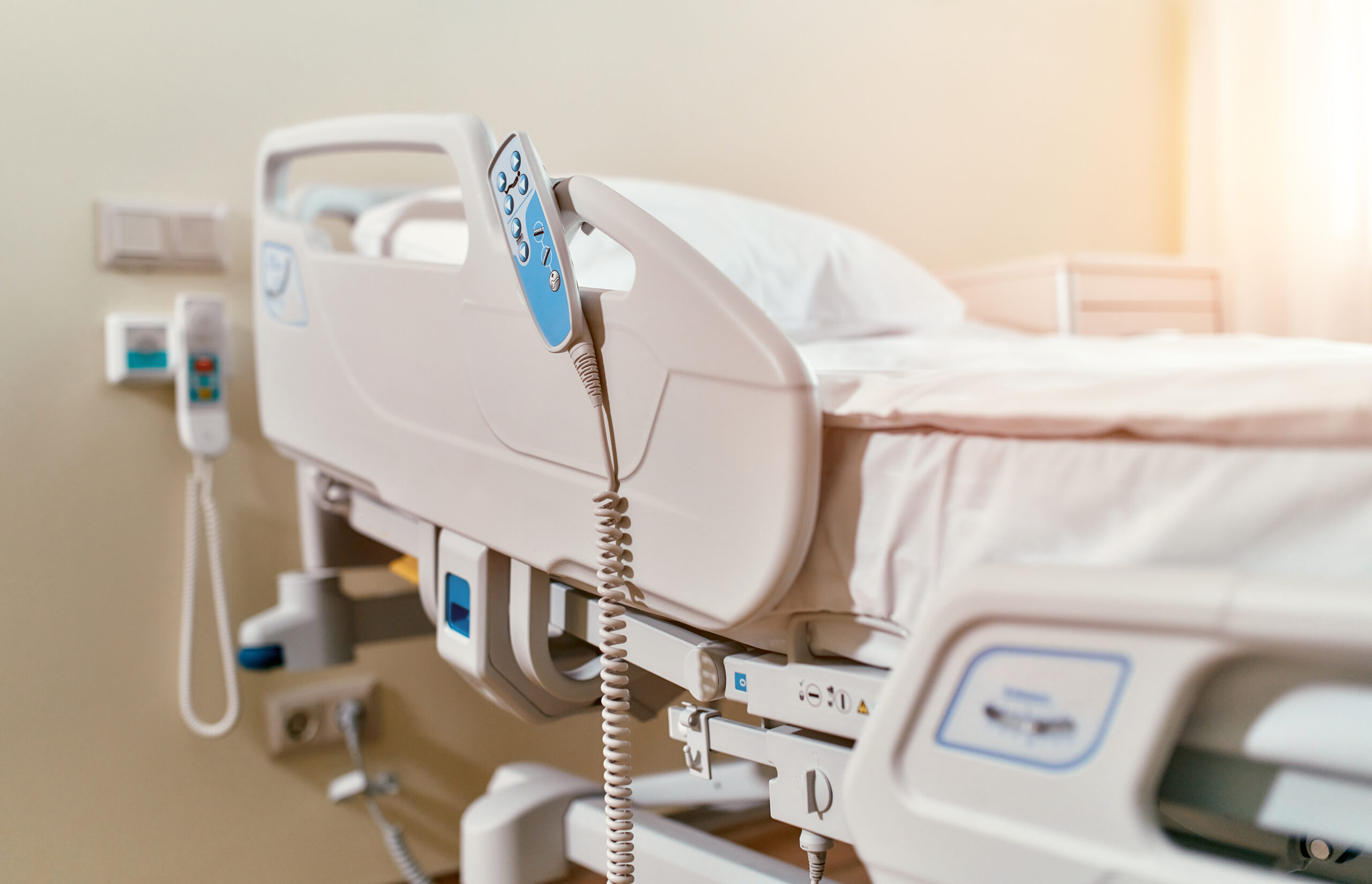 Hospital bed with electric controls for adjusting height and position.