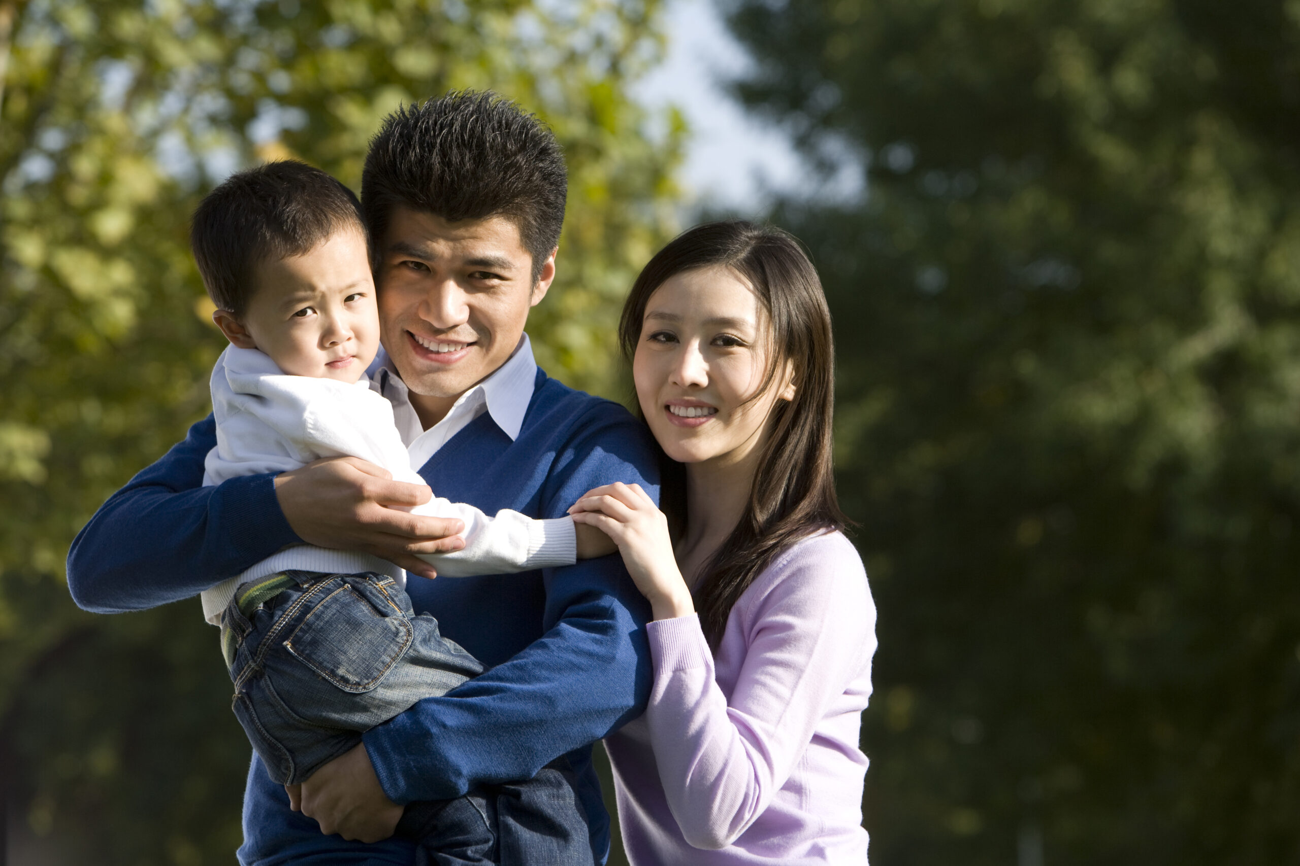 Happy Asian family: father, mother, and young son.