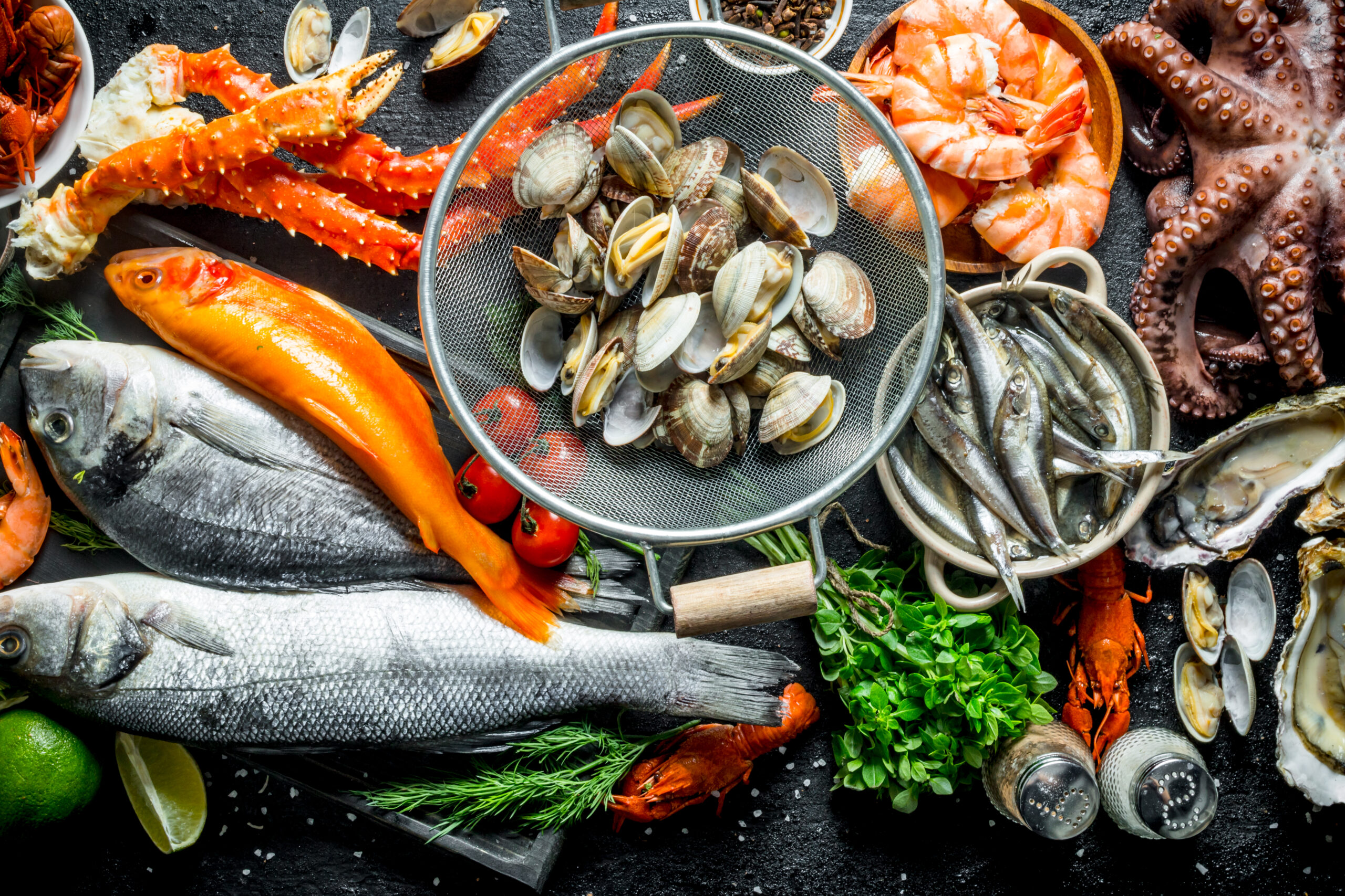 Variety of fresh seafood including fish, shellfish, and crustaceans.