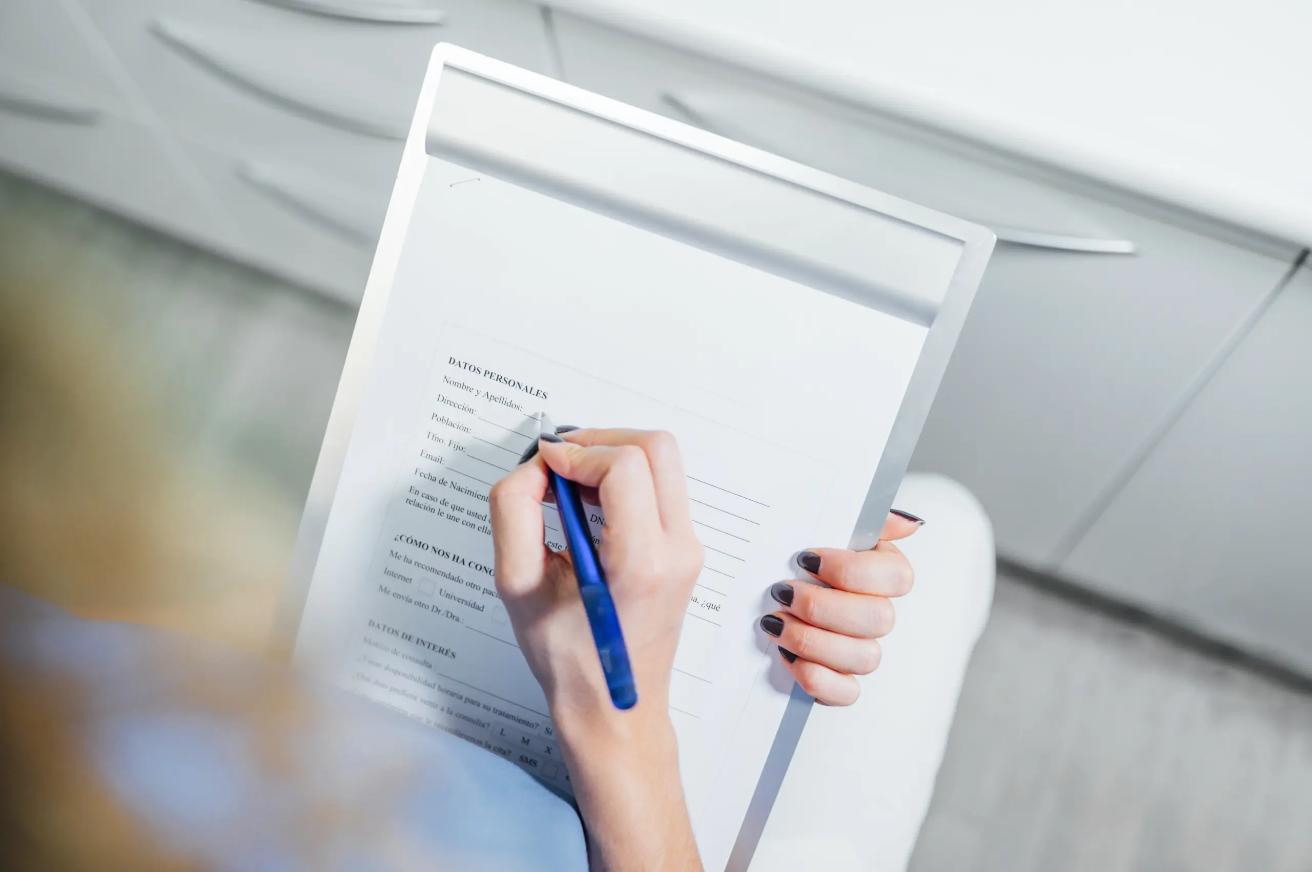 Person filling out a patient intake form.