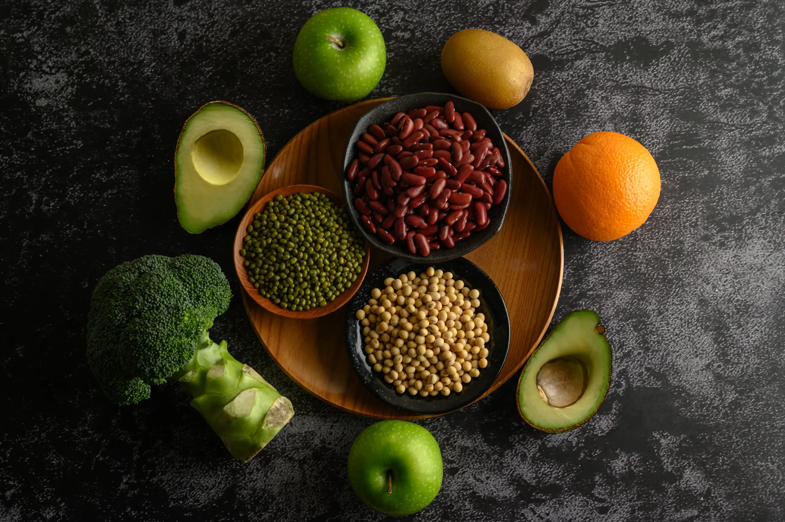 Healthy ingredients: beans, fruit, avocado, broccoli platter